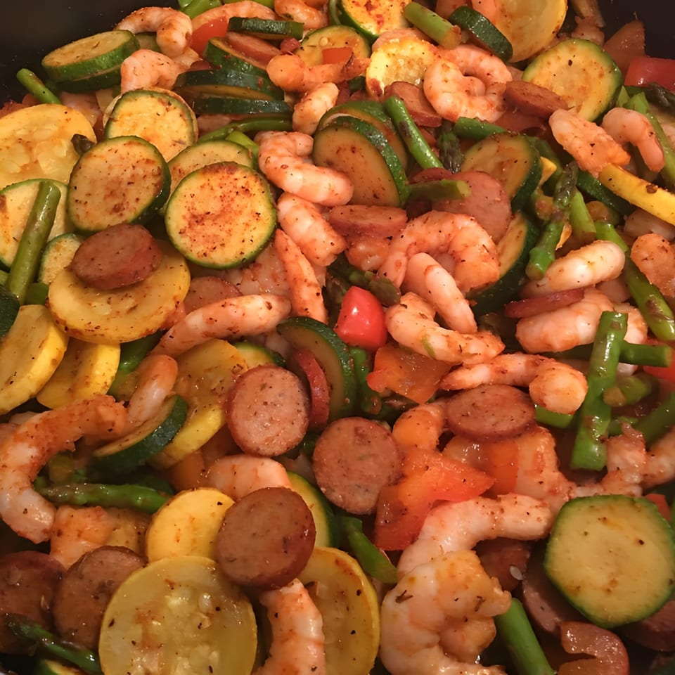 Close-up of Gail's Soul Food shrimp, sausage, zucchini, and squash medley.