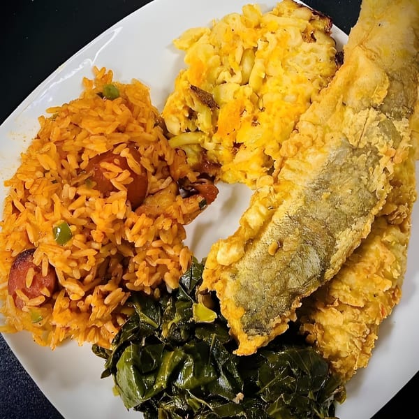A Gail's Soul Food plate with fried fish, jambalaya, macaroni and cheese, and collard greens.