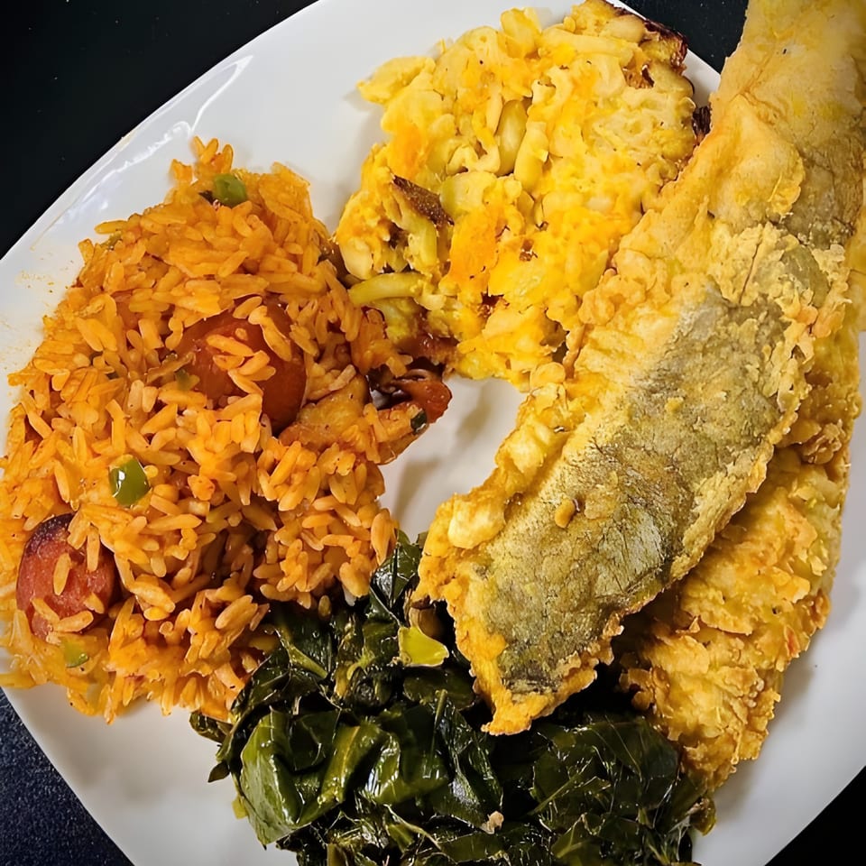 A Gail's Soul Food plate with fried fish, jambalaya, macaroni and cheese, and collard greens.