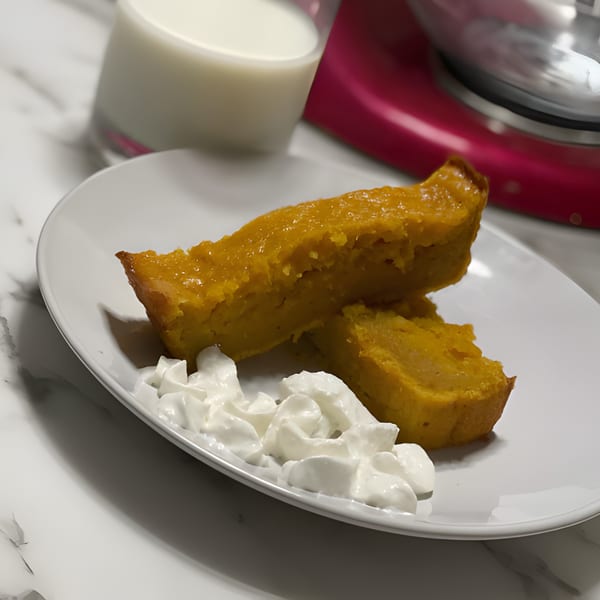 Two slices of Gail's Soul Food sweet potato pie with whipped cream, milk, and a mixer.